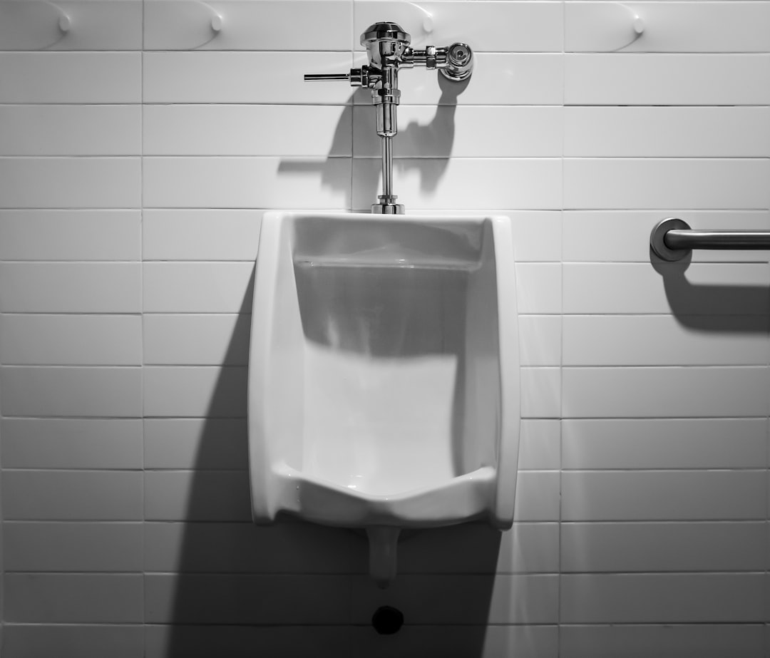 a-urinal-mounted-to-a-wall-in-a-bathroom-0xzzvxyf41a